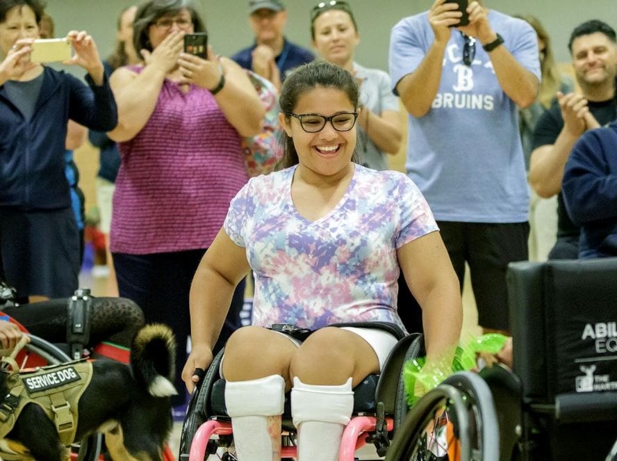 Olivia Curcuru presented with custom wheelchair at Angel City Games, 2019.