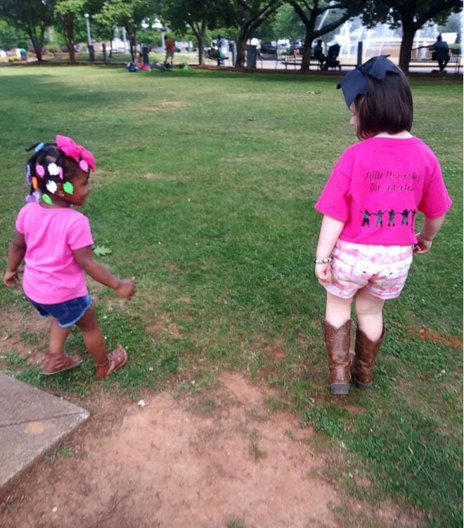 Tynslee Blue, 5, and a friend help distribute care packages to the homeless in a local park.