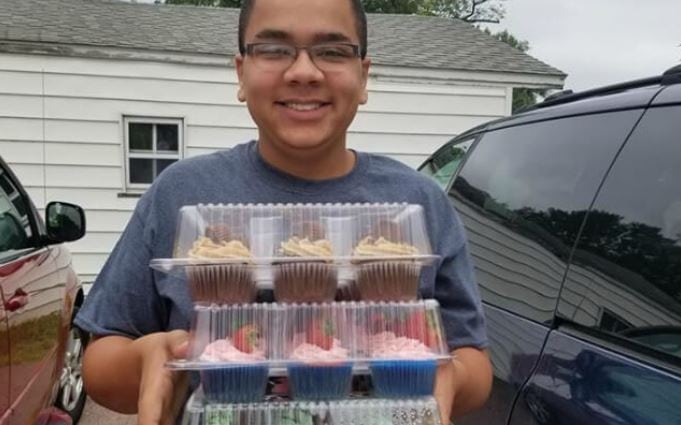 14-year-old Isaiah Tuckett delivers cupcakes for a large graduation party order. 