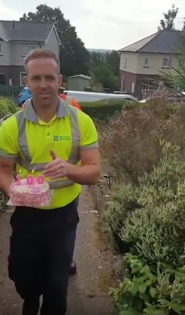 Garbage men surprise elderly woman on her 100th birthday with a cake and a little happiness. Credit: Ben Bird