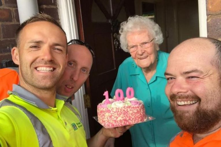 Garbage men surprise elderly woman on her 100th birthday with a cake and a little happiness. 