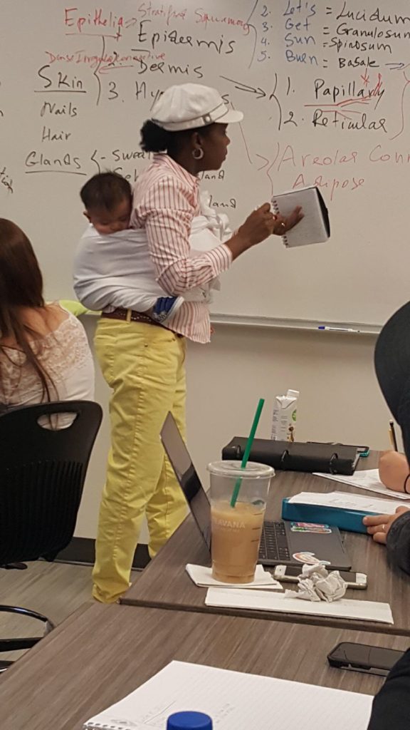 Professor holds her student's baby during a 3-hour lecture so the mom can focus and take notes.