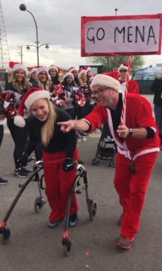 Girl with cerebral palsy overcomes the odds to finish annual Santa Run in record time using a walker. 