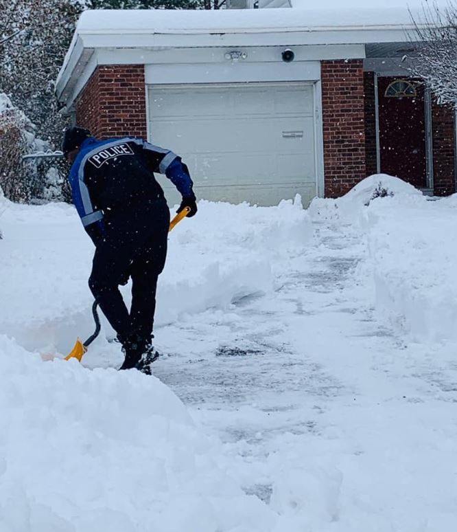 A trio of compassionate police officers shovel 12 inches of snow for a 99-year-old woman who lives alone.