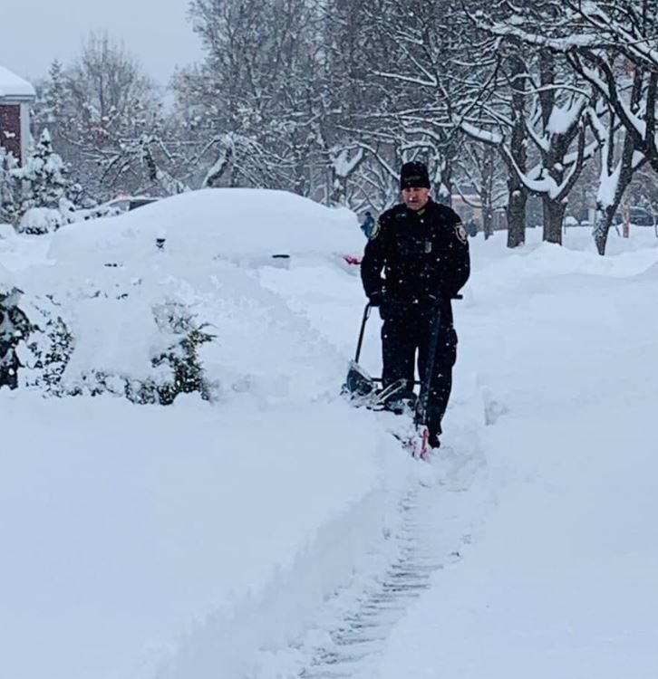 A trio of compassionate police officers shovel 12 inches of snow for a 99-year-old woman who lives alone.