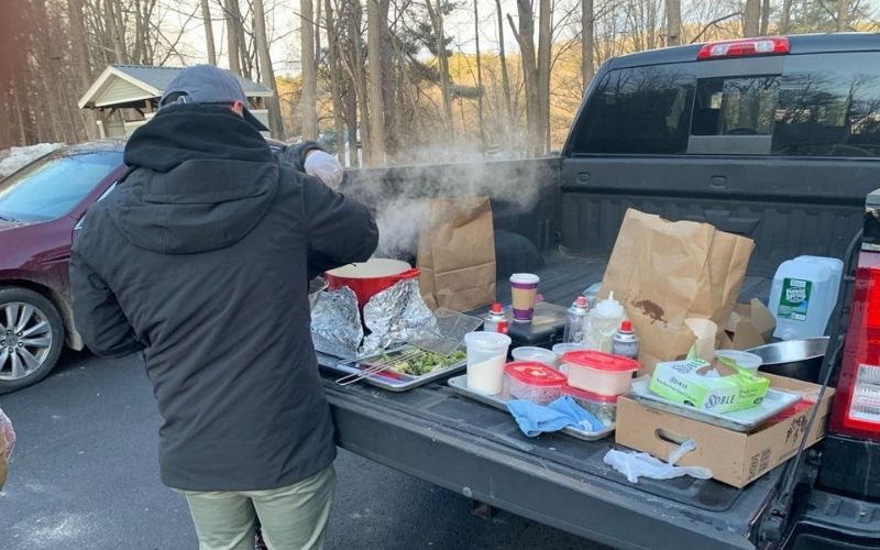 Steve Chu prepares a customer’s favorite broccoli in the parking lot of her Vermont condo building