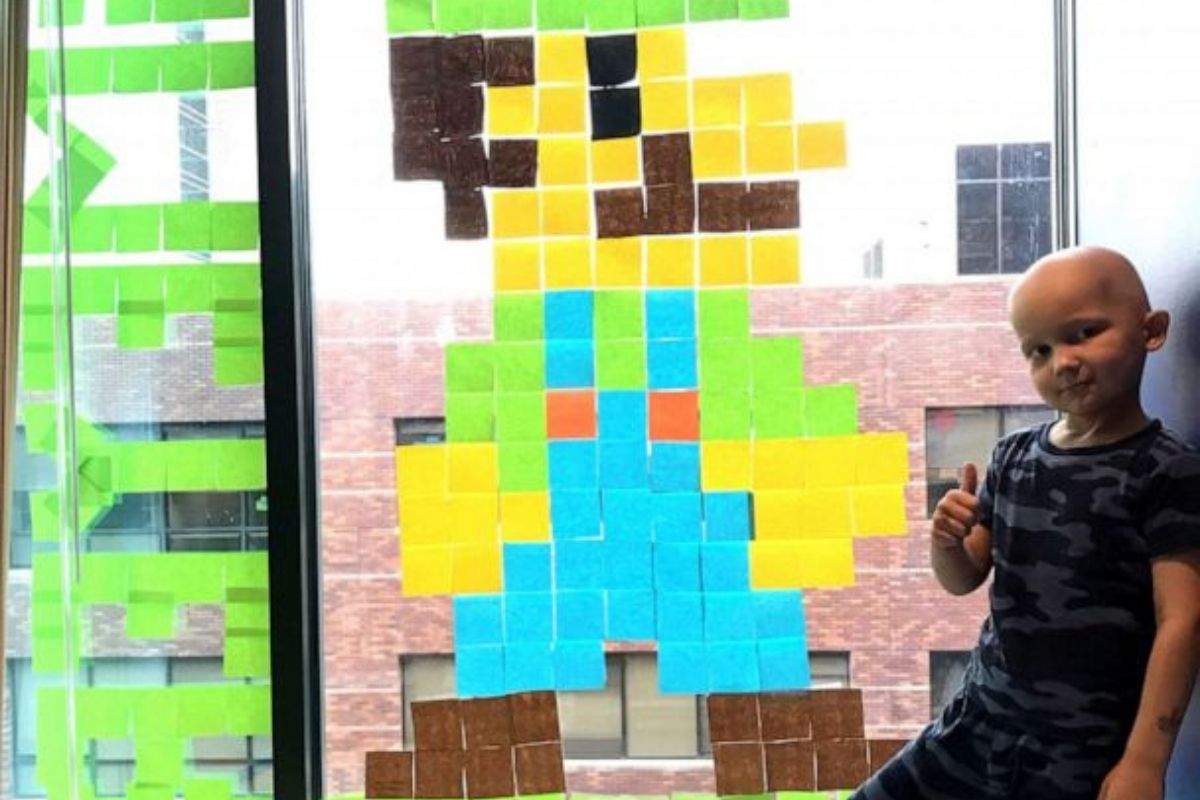 Boy undergoing cancer treatment makes new friends with hospital staff across the street using Post-it notes.