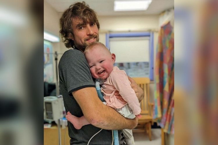 James Foster holds Bradi while she's still in the NICU.